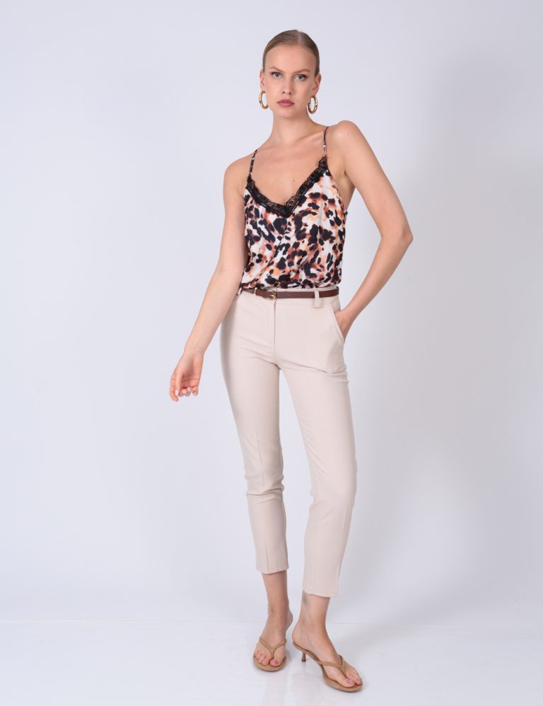 Leopard print top with lace detail and beige slim-fit pants – chic and comfy outfit for day or night.